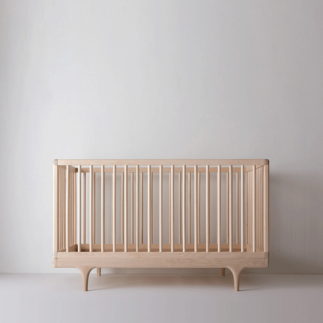 Front view of Kalon Caravan Crib frame in -- Color_Oiled Ash