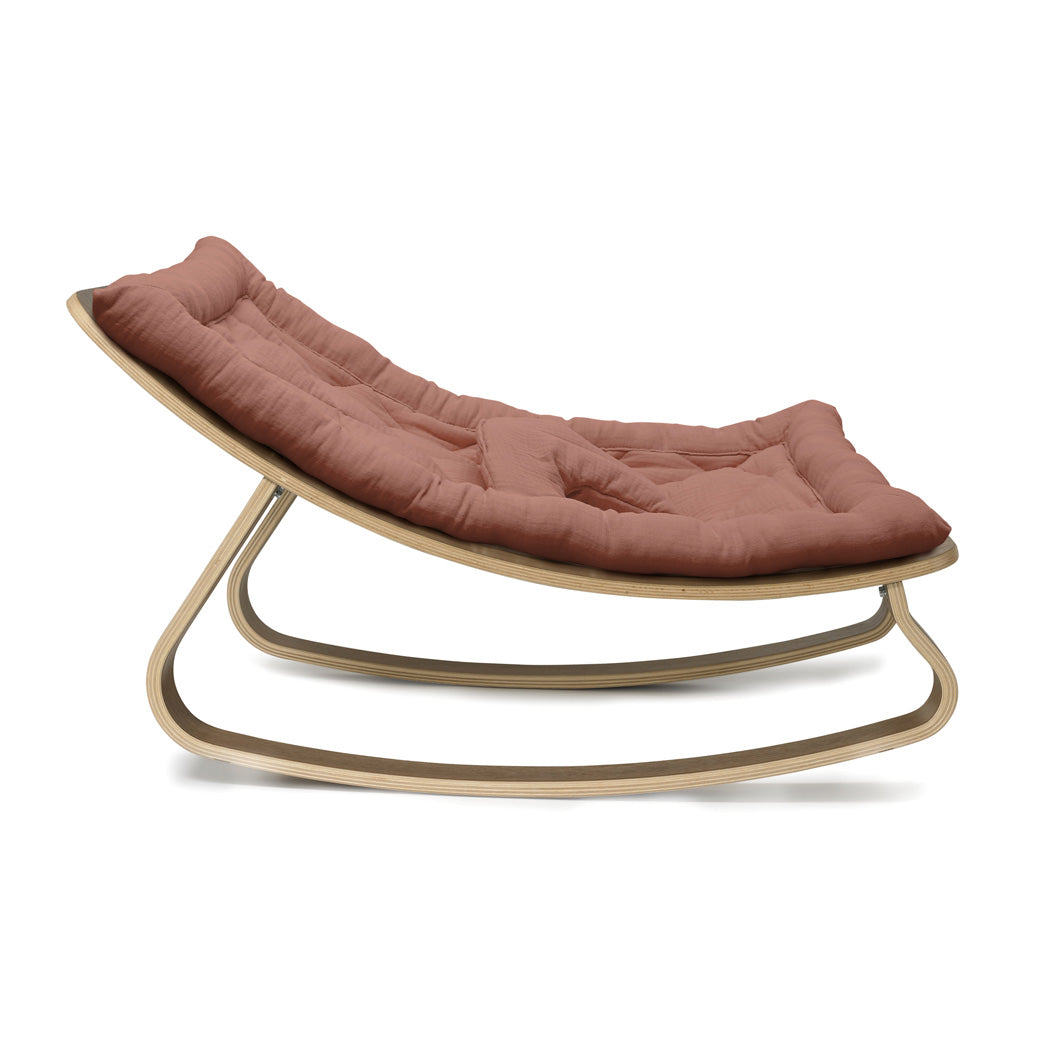 Profile View of Charlie Crane LEVO Baby Rocker in -- Color_Bois de Rose _ Walnut