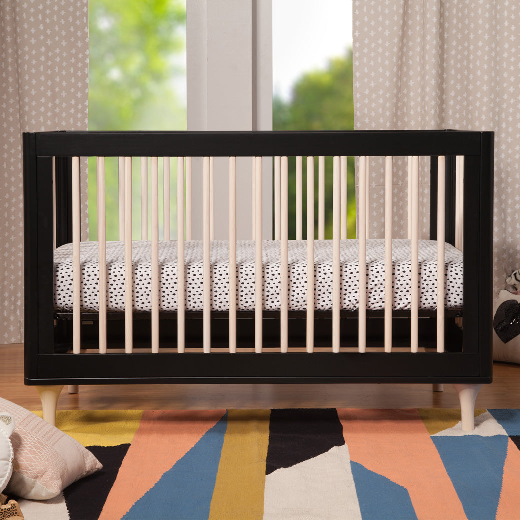 Profile view in baby room of Babyletto Lolly 3-in-1 Crib in Black