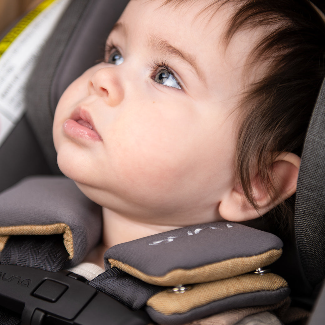 Close up of babies face in the Nuna PIPA lite rx + RELX base in -- Color_Camel
