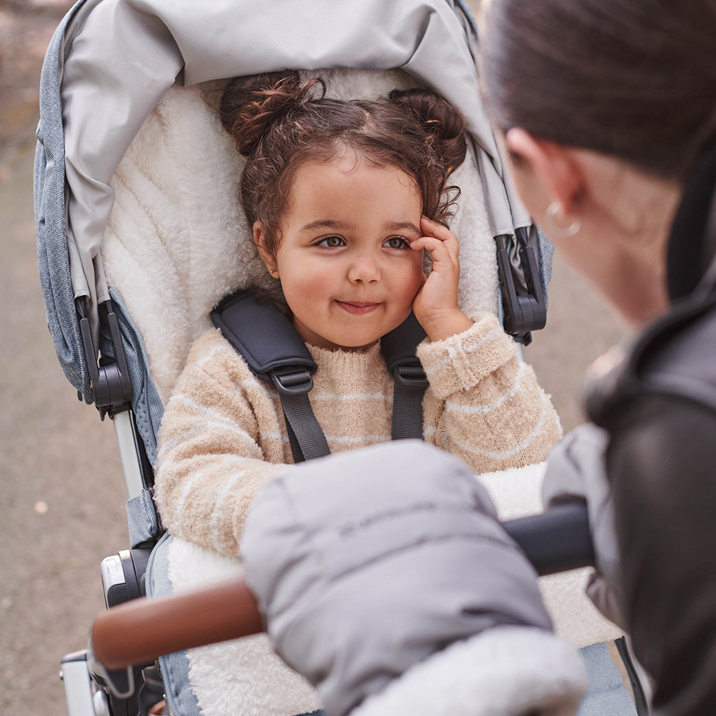 Child sitting in the vista v2 stroller while looking at woman -- Color_Gregory