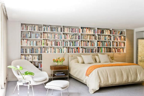 Bedroom surrounded by bookshelves