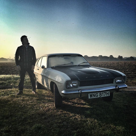 A man next to a Ford Capri in Essex countryside