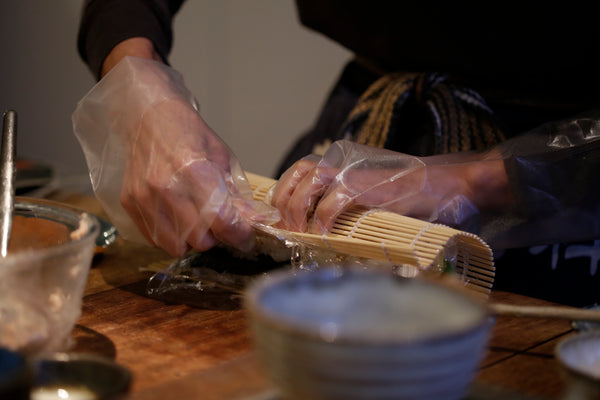 rolling up a sushi roll