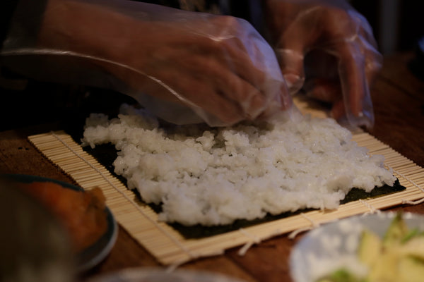 spreading rice on nori sheet