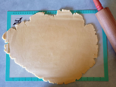 Rolled out cookie dough ready for cutting into cookie cake shape