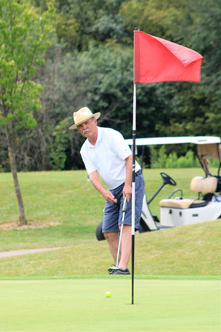 Man Chipping at Golf Tournament