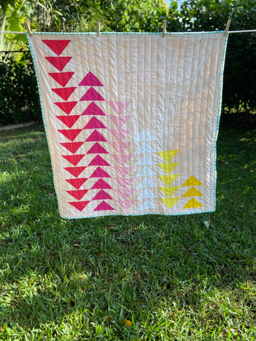 pink and yellow modern flying geese quilt