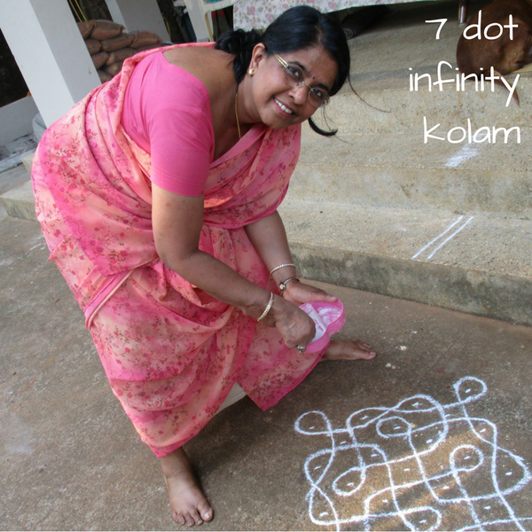 drawing a kolam in the morning