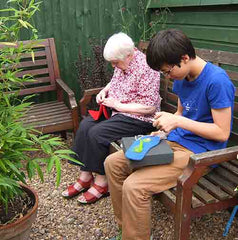 Joe and grandma sewing Joe's Toes kits