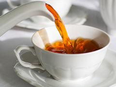 Pouring tea into a cup
