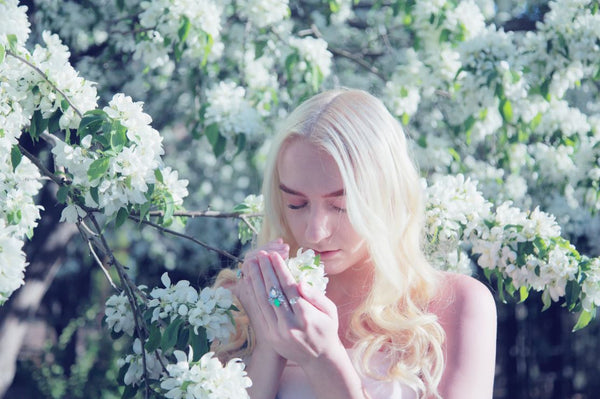 woman smelling flowers