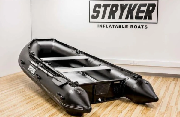 A very large grey and black inflatable Stryker boat. 
