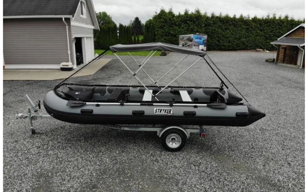 A large inflatable boat loaded on a trailer. 
