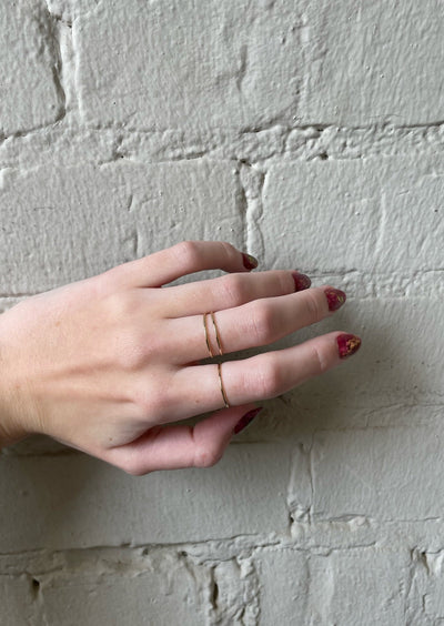 Women's hand with simple gold rings