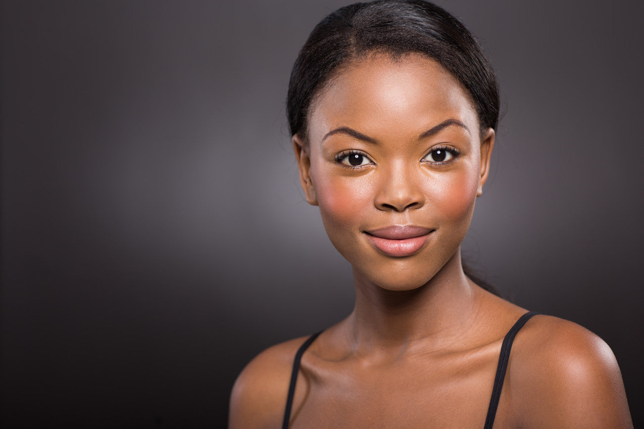 Woman posing in front of a dark background
