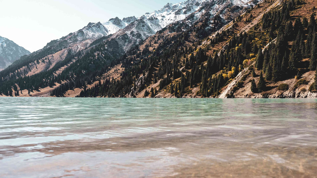 body of water near mountain during daytime photo