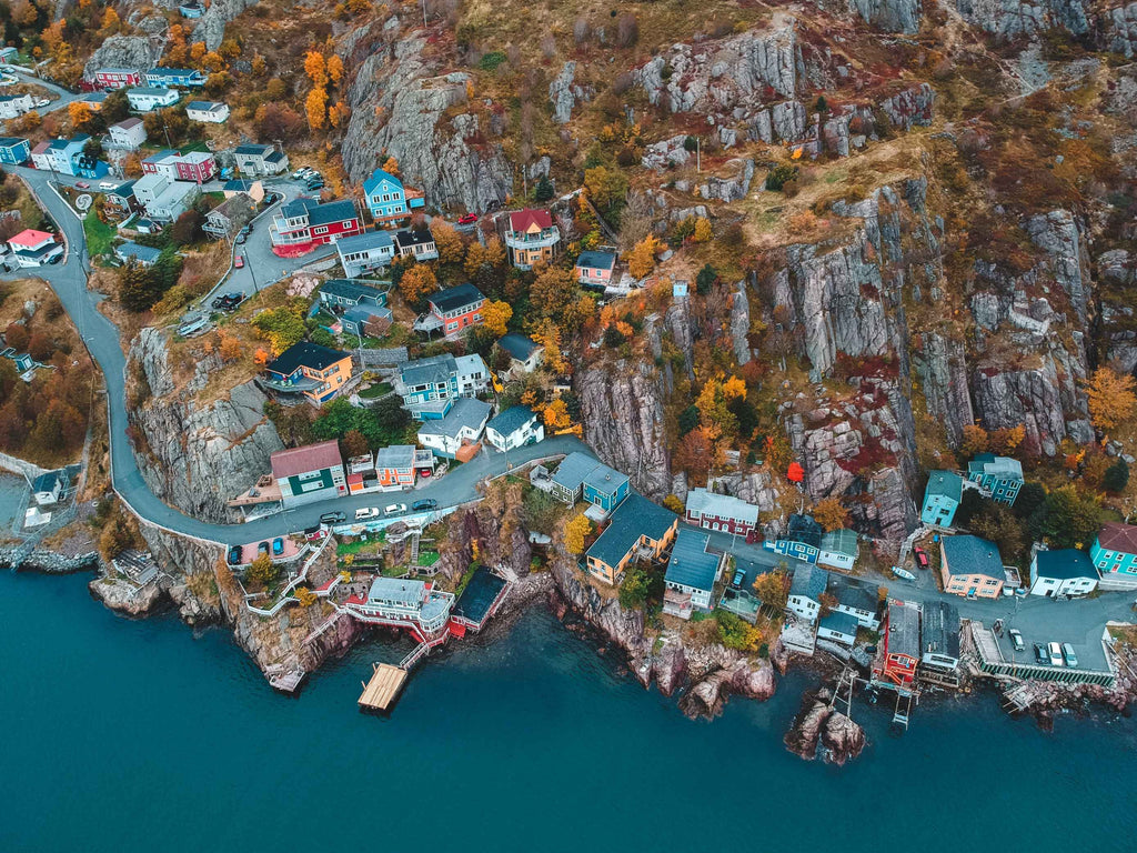 aerial photography of houses and buildings near blue body of water during daytime photo