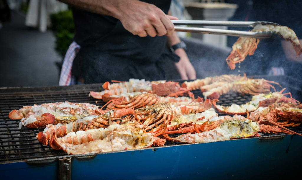 man grilling crabs during daytime photo