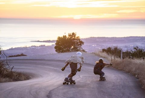 Downhill longboarding in the sunset