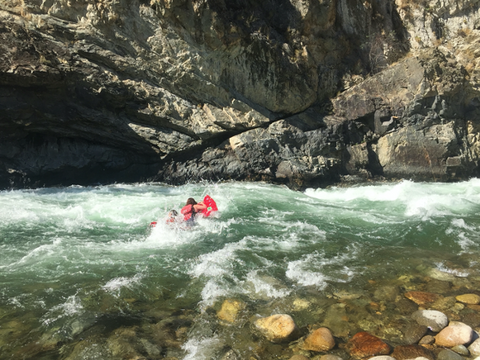 A friend of Jelt pictured riding a rapid on a river with a Paco Sleeping Pad