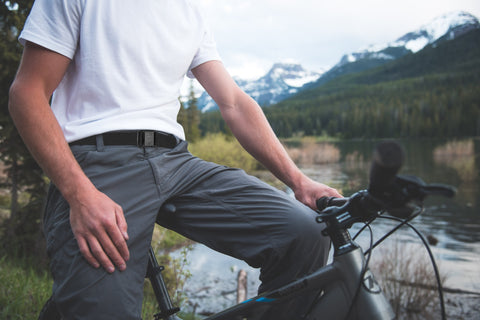 Man wearing a JeltX Adjustable belt on pants while mountain biking