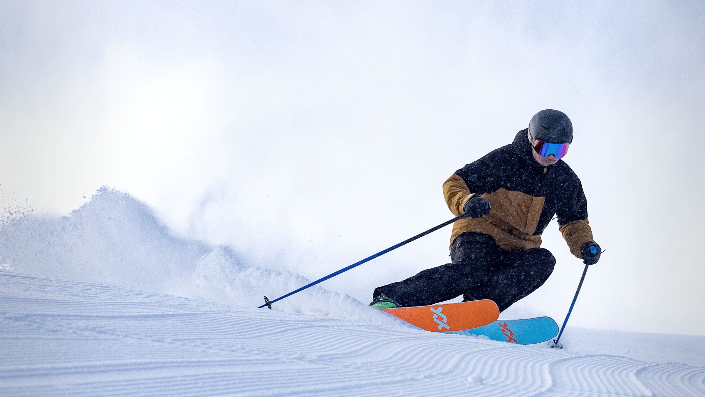 George Rodney carving a turn in the black summit ski pant