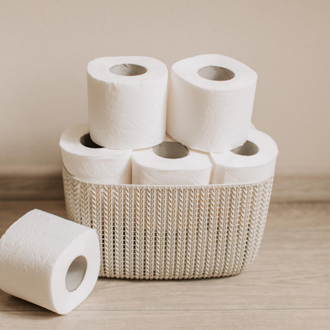 toilet paper stacked in a basket