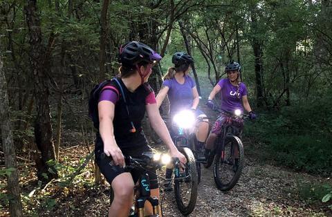 MOUNTAIN BIKERS ON GROUP RIDE WITH LIGHTS