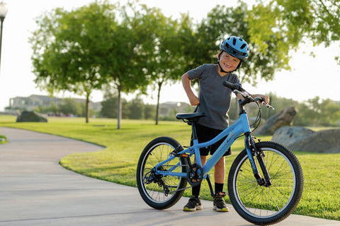 YOUNG CYCLISTS SMILING IN THE PARK