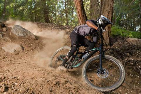 MOUNTAIN BIKER CORNERS A SANDY TURN