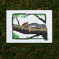 An art print of a squirrel lounging in a tree.