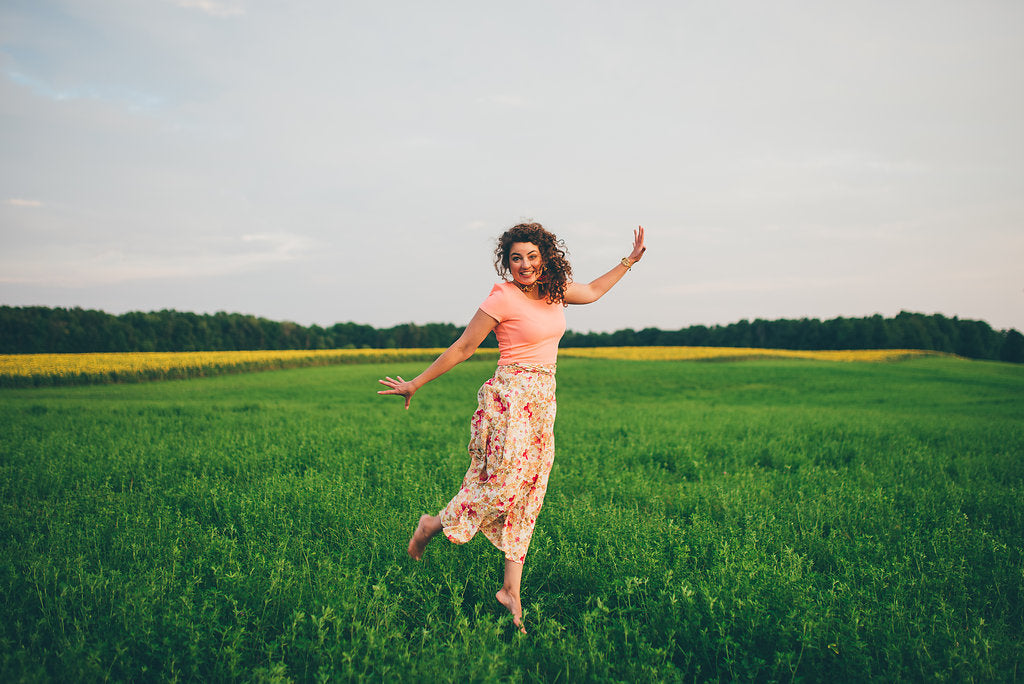 Hattie jumps for joy in a field