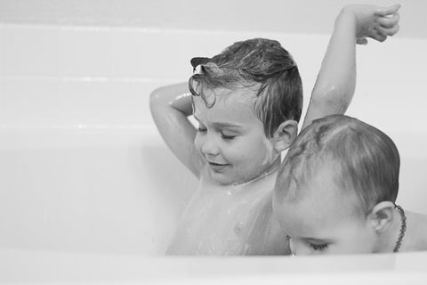 Black and white photo with Kelly Fondot's children playing in bathtub