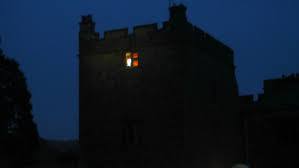 Old castle like house, light in the distance, window 