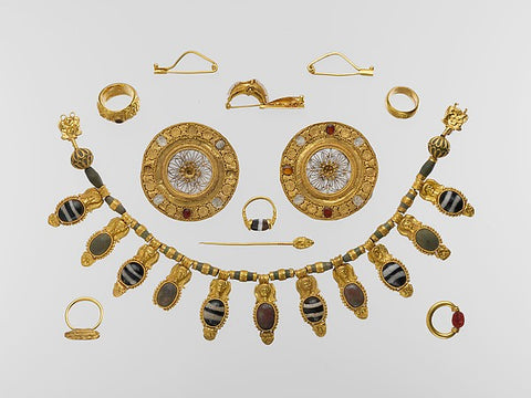The tomb group represents one of the richest and most impressive sets of Etruscan jewelry ever found. It comprises a splendid gold and glass pendant necklace, a pair of gold and rock-crystal...