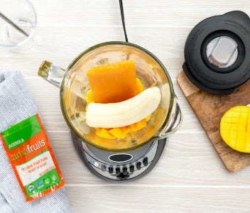 Acerola Mango smoothie ingredients placed into standard blender