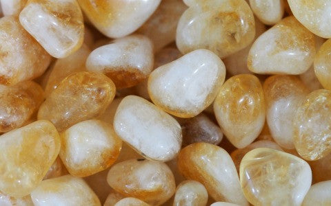 An image of citrine tumbled stones