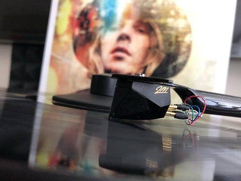 Close-up of a 2M Black playing a copy of Beck's album "Morning Phase"