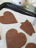 Chocolate cookie cut outs ready to be baked