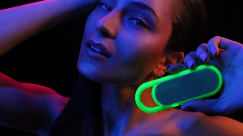Girl listening to the Candywirez wireless/ portable neon speaker 