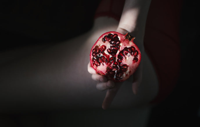 Woman holding pomegranate