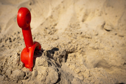 plastic garden tool toy in sand 