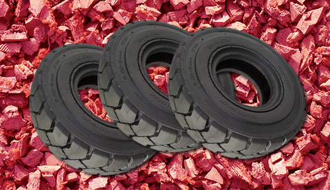 tires on a bed of red mulch