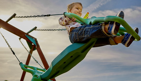 child riding a playground ride
