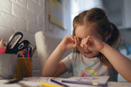 Little girl rub eyes colouring — SaferOptics