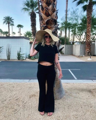 Downtown Betty's Black Airplane Outfit  in Short Sleeve Crop T + Boho Bell Bottoms in front of Palm Trees in Palm Springs 