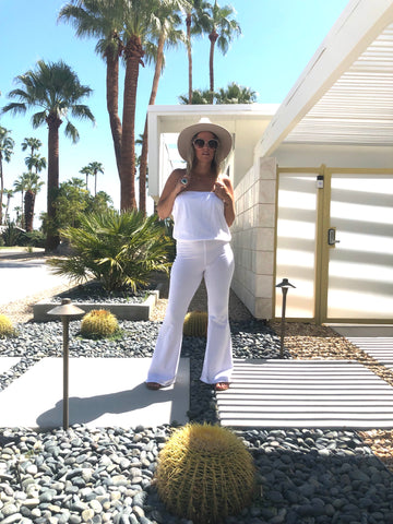 Downtown Betty in the Kundalini Whites Villa Onepiece in front of cactus, palm trees & beautiful modern Palm Springs home