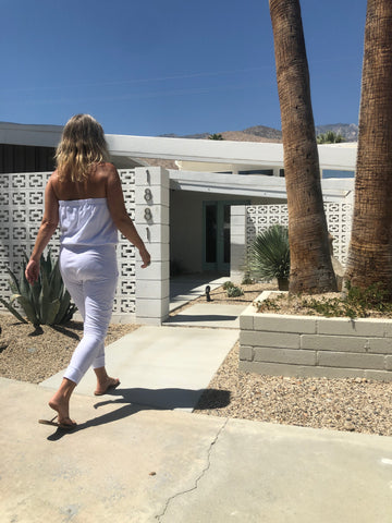 Chandara Playsuit in Kundalini Whites back view in front of Palm Springs home