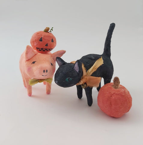 spun cotton pig and black cat, standing next to pumpkin